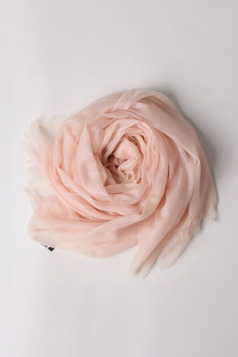 The looselyboho Blush Rose 100% Cashmere Scarf is styled in a loose spiral on a white background, highlighting the elegance of this luxury winter accessory.