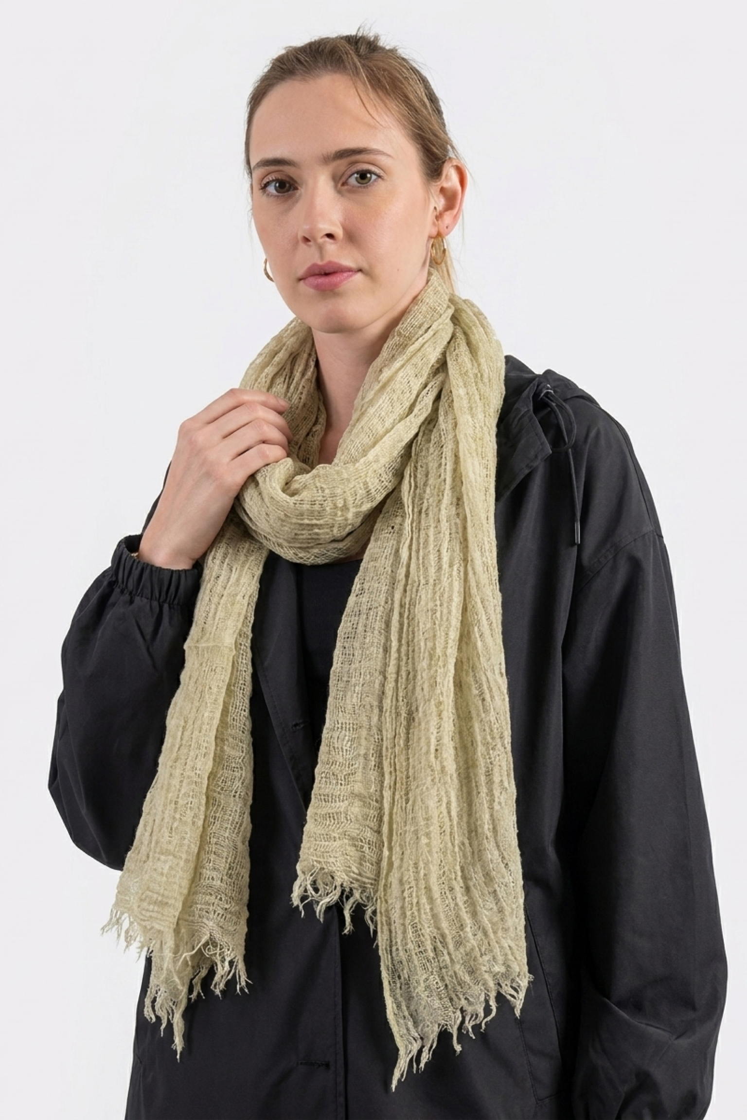 A person with light hair models the Lightweight Linen Scarf and a black jacket against a white background, facing the camera with a neutral expression—highlighting this stylish and versatile accessory.