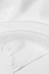 A close-up of the looselyboho Ivory Whisper 100% Cashmere Scarf, featuring a smooth, minimalist texture and soft fringed edges, elegantly laid flat with gentle folds to showcase luxurious simplicity.